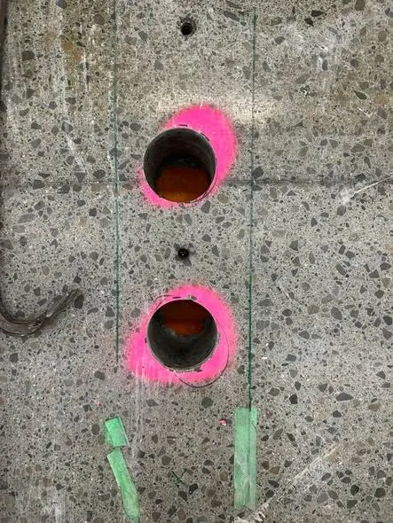 Core holes in a South Canterbury supermarket floor slab with the drilled concrete cores lifted out and standing beside them