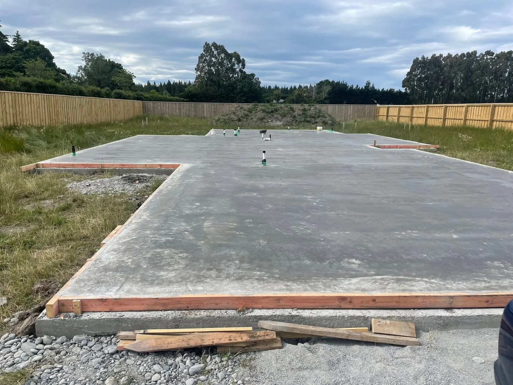 Saw cuts run across a new house slab at Rakaia in Mid Canterbury, flat farmland behind