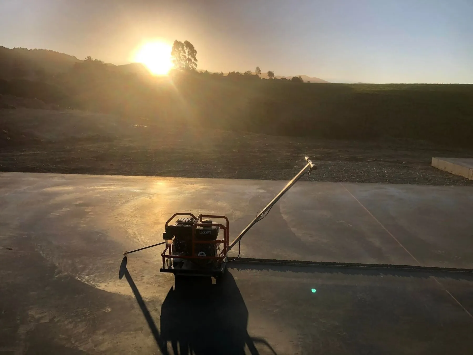 Saw cuts finished in a new house slab at Waimate, South Canterbury, with the sun going down behind it