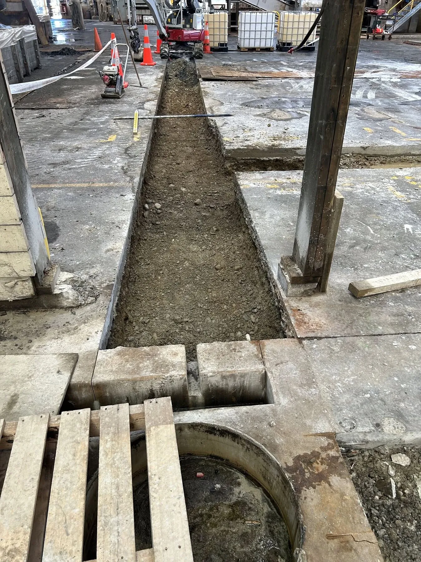 Trench dug to depth through a factory floor in Timaru, tying in to an existing drainage chamber
