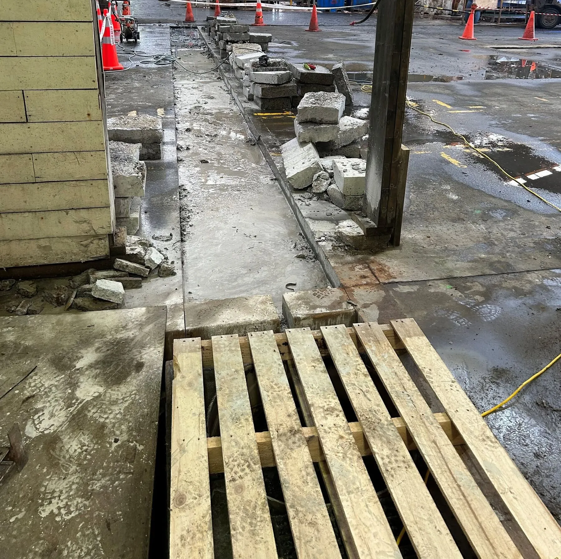 Concrete floor slab broken out along the saw cut line inside a Timaru factory