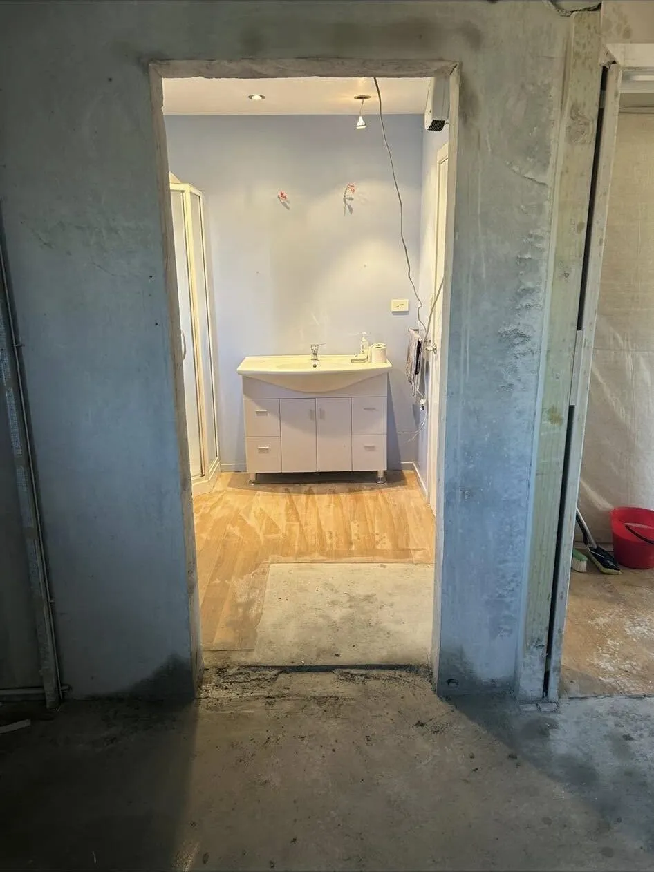 Finished doorway opening cut through an interior concrete wall in South Canterbury, looking through to the room beyond
